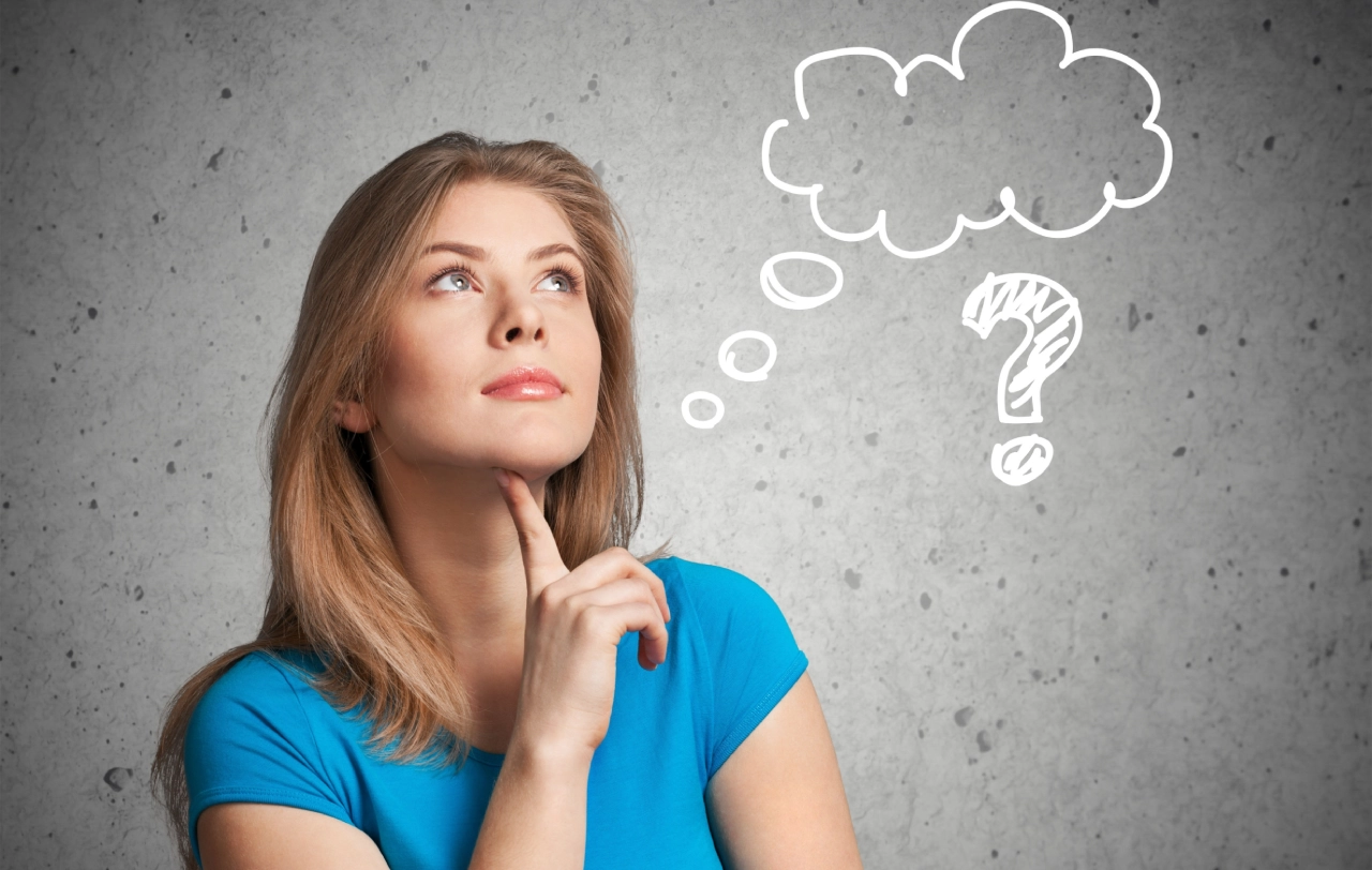 A woman is looking up at the thought bubble above her head.