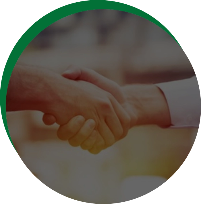 Two people shaking hands over a green circle.