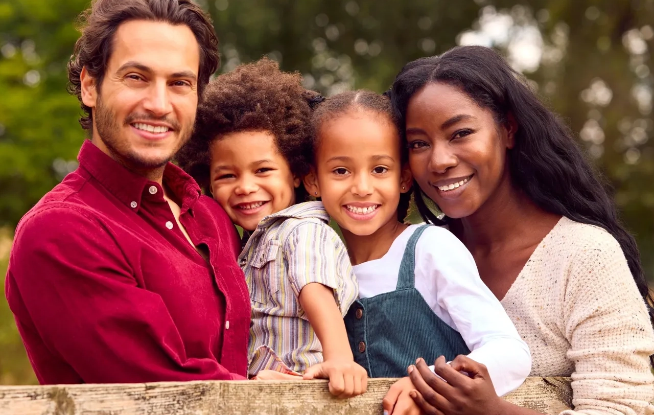 A family of four posing for the camera.